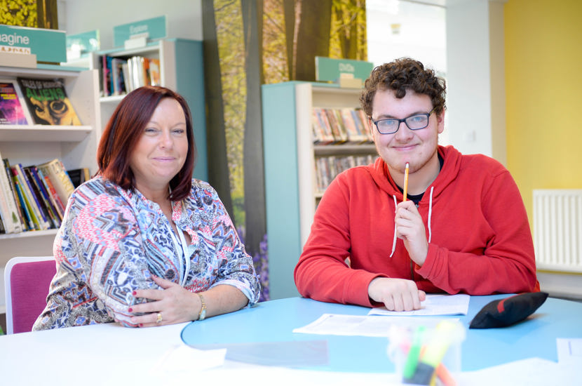 Student and staff in the library