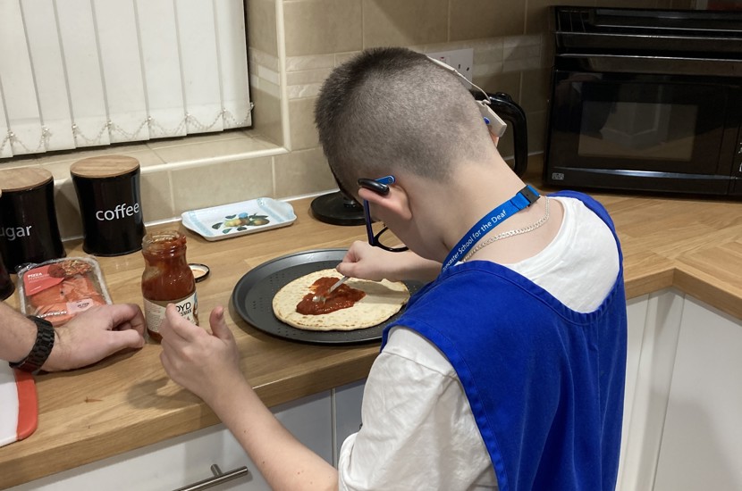 Dickson House resident making a pizza