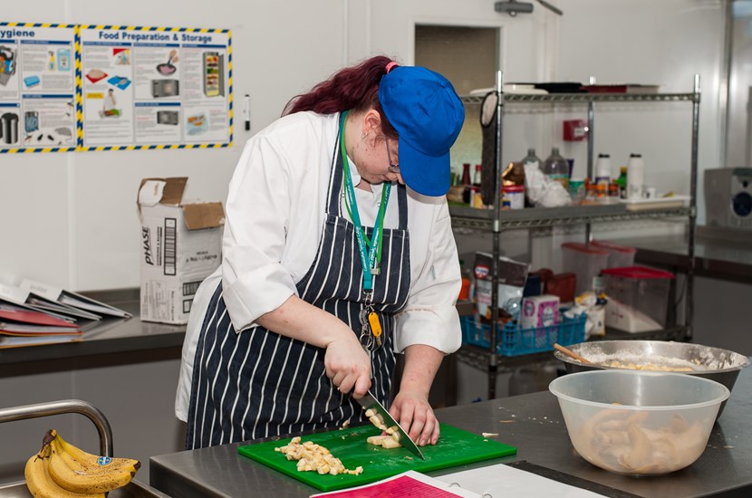 student preparing food in the kitchen