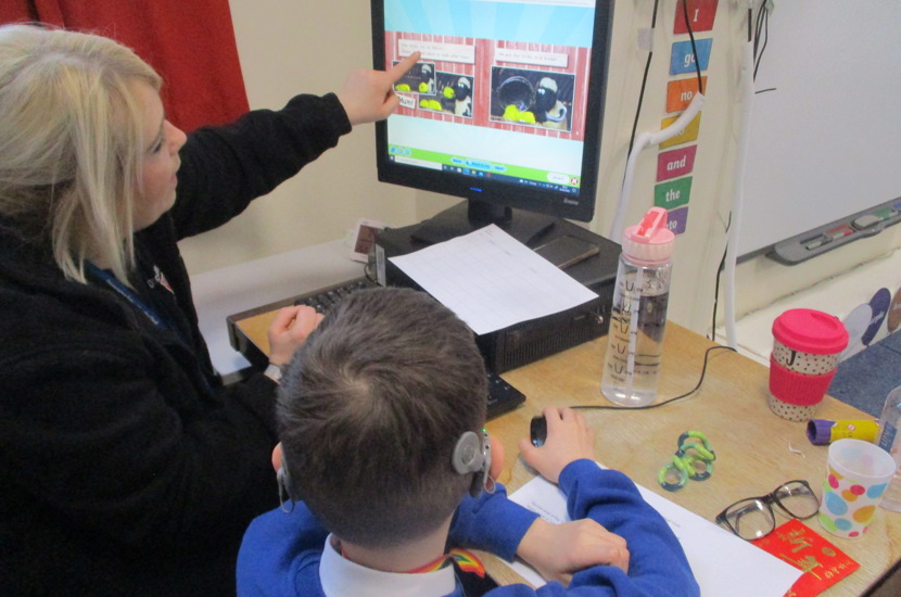 Doncaster School for the Deaf pupils with support worker at a computer