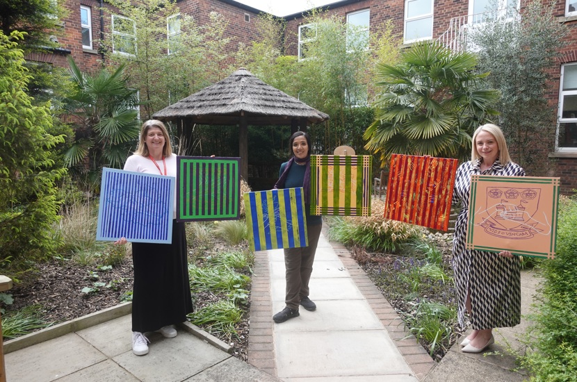 Artist Rubbena Aurangzeb-Tariq (centre) showcasing her artwork with (L) Natalie Pollard, BSL manager at Doncaster Deaf Trust, and (R) Tracey Jamison, interim principal at Communication Specialist College Doncaster.
