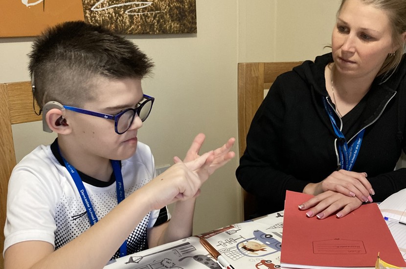 Dickson House Resident signing with staff member 