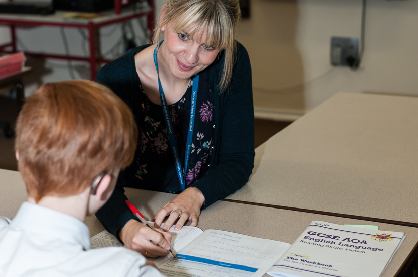 Teacher supporting a pupil