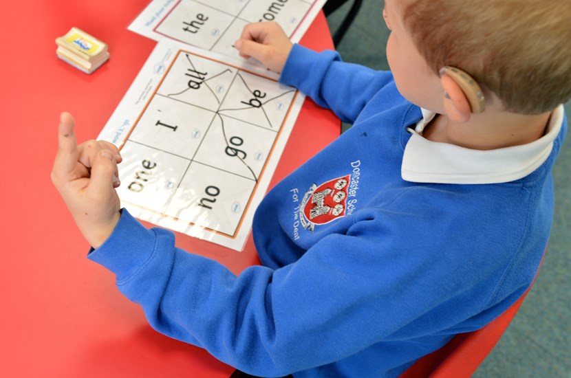 school pupil learning words and signs 