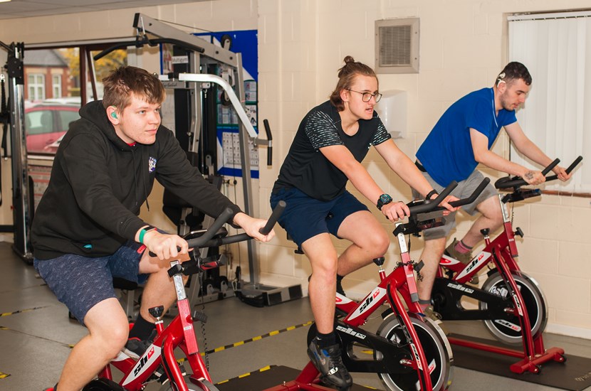 students on bicycles in the gym