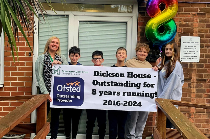Dickson House Staff and Pupils With Outstanding Ofsted Banner